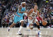 Denver Nuggets forward Aaron Gordon, right, drives past Phoenix Suns forward Torrey Craig in the first half of an NBA basketball game, Sunday, Dec. 25, 2022, in Denver. (AP Photo/David Zalubowski)