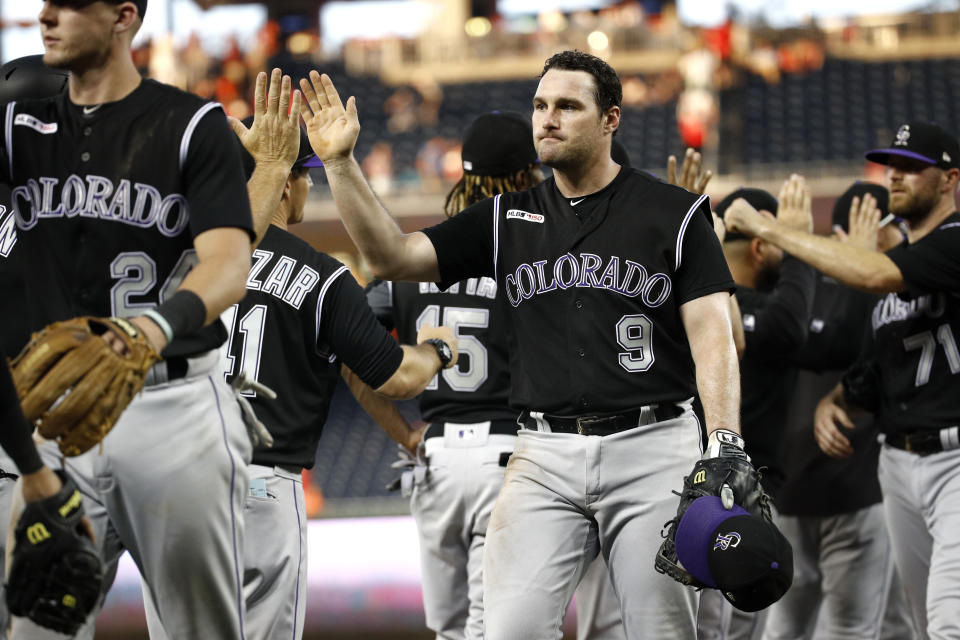 Colorado Rockies' Daniel Murphy (9) high-fives teammates after a baseball game against the Washington Nationals, Thursday, July 25, 2019, in Washington. Colorado won 8-7. (AP Photo/Patrick Semansky)