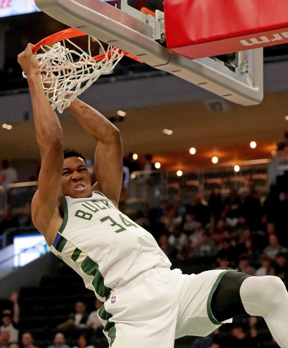 Milwaukee Bucks forward Giannis Antetokounmpo (34) hangs on to the rim after dunking during the game against the Oklahoma City Thunder at Fiserv Forum in Milwaukee on Sunday, Oct. 10, 2021.    -  Photo by Mike De Sisti / Milwaukee Journal Sentinel via USA TODAY NETWORK