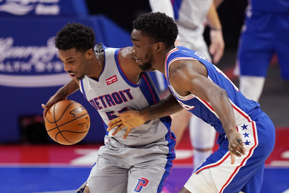 Detroit Pistons guard Delon Wright (55) steals the ball away from Philadelphia 76ers guard Shake Milton during the second half of an NBA basketball game, Monday, Jan. 25, 2021, in Detroit. (AP Photo/Carlos Osorio)