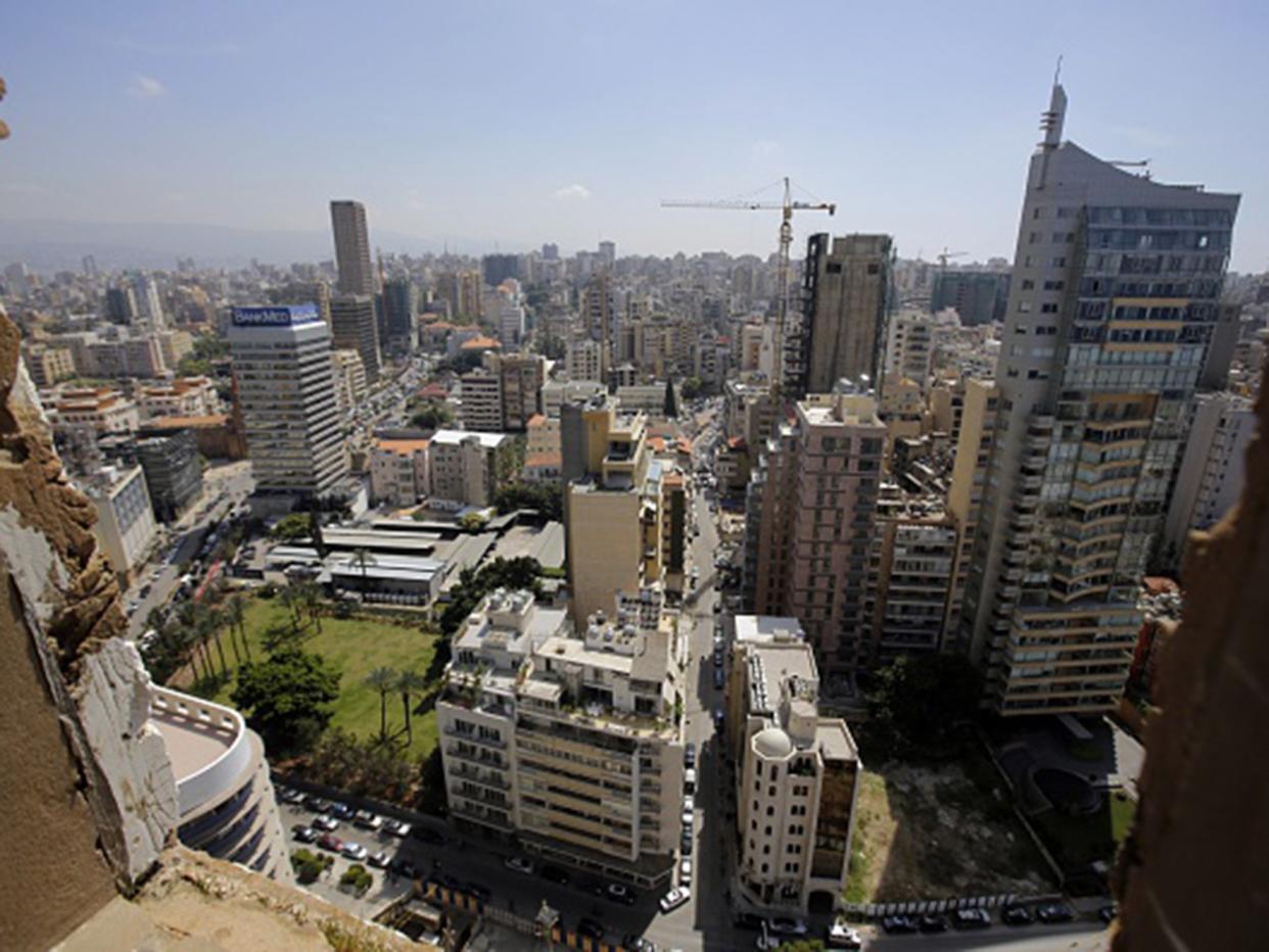 An area of West Beirut is seen through a window of the abandoned building of the Holiday Inn hotel: AFP