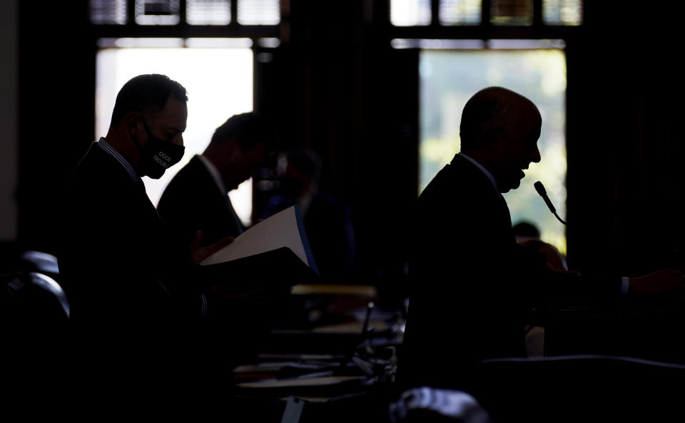 Rep. Chris Turner, D-Arlington, right, and Rep. Rafael Anchia, D-Dallas, left, line up to speak against HB 6, an election bill, in the House Chamber at the Texas Capitol in Austin, Texas, Thursday, May 6, 2021. (AP Photo/Eric Gay)