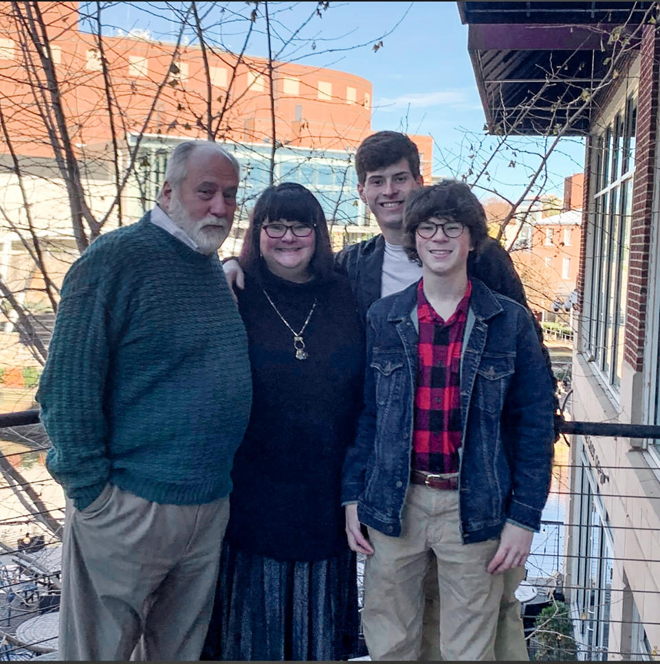 In this 2019 photo released by Shelley Summer, Greenville resident John Wickersham, left, father of Shelley Summer, center, with her two sons Briggs Summer and Davis Summer at the Lazy Goat in downtown Greenville, S.C. Shelley Summer says she and her 75 year old father struggled to get him a COVID-19 vaccination appointment, navigating complicated online scheduling systems. (Shelley Summer via AP)