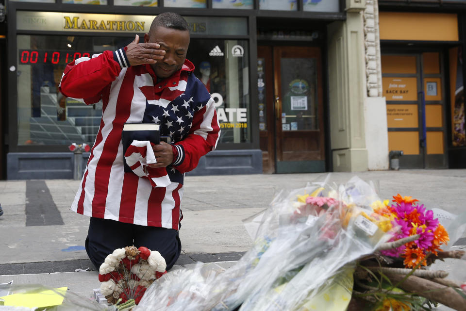 A man is seen praying in front of a Boston Marathon bombing memorial on the occasion's five-year anniversary. People who watched repeated, graphic footage of the bombing exhibited mental and physical stress, research found. (Photo: Jessica Rinaldi/The Boston Globe via Getty Images)