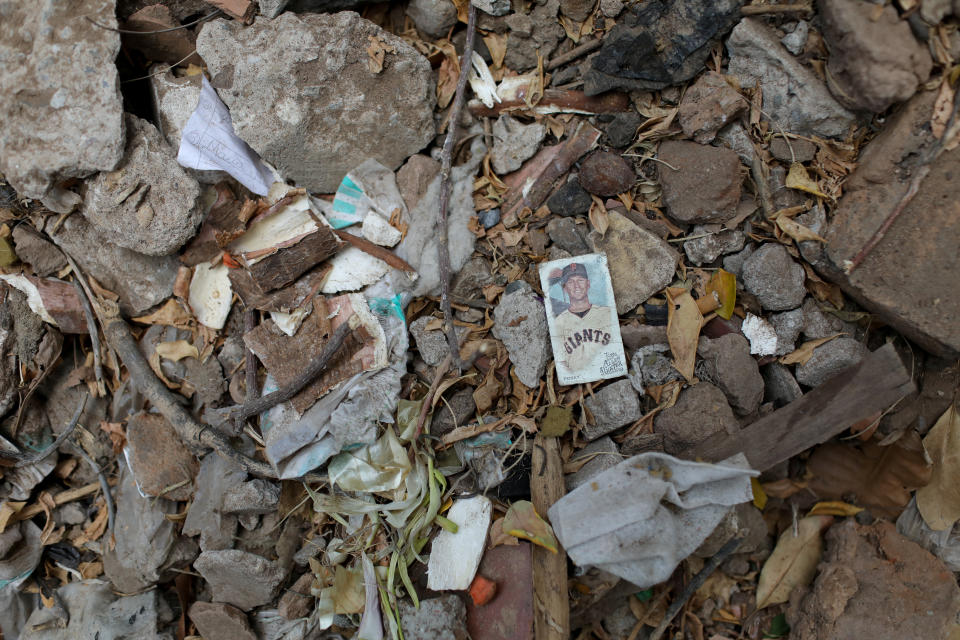 A card showing a major league player is seen on the ground of little league baseball player Adrian Salcedos sister's yard in Maracaibo, Venezuela. (Photo: Manaure Quintero/Reuters)