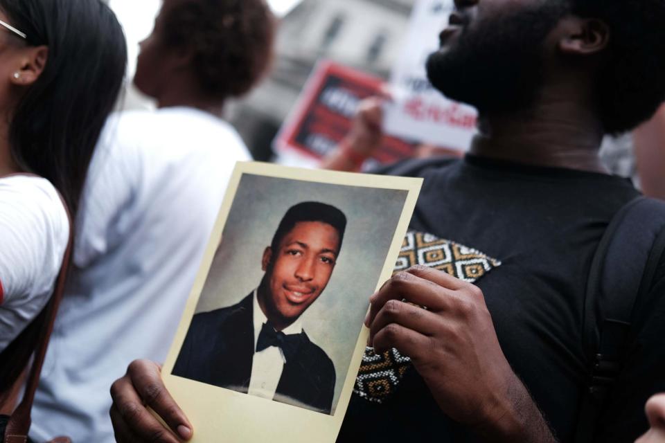 Protester holds image of Eric Garner, who repeatedly said 