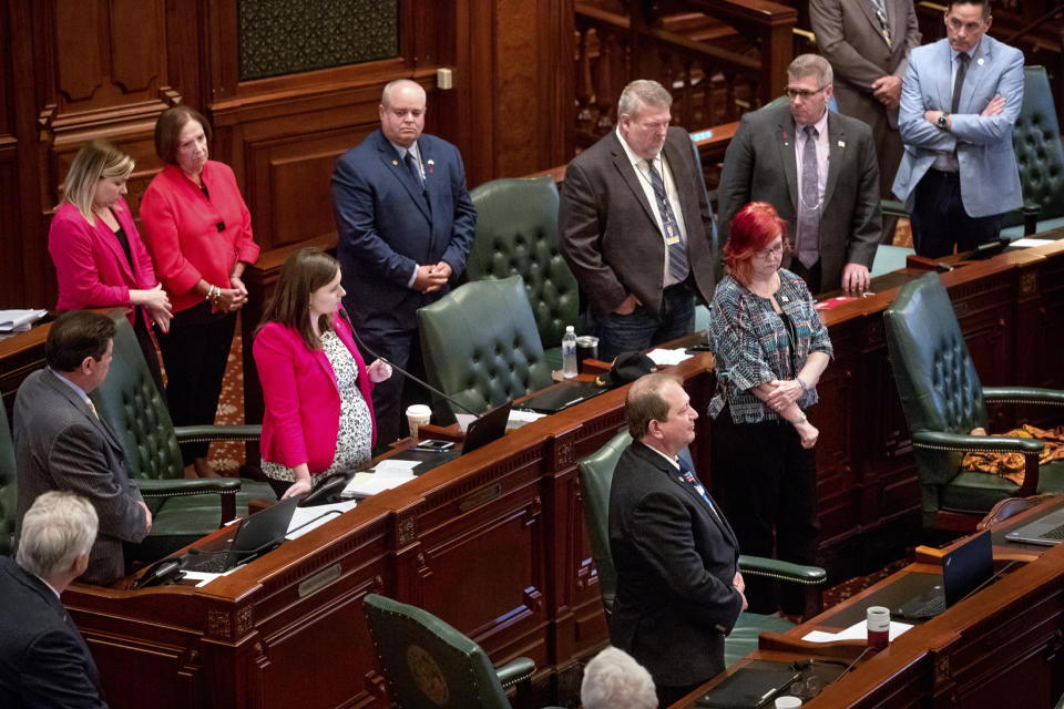 As her colleagues stand around her, Illinois state Rep. Avery Bourne, R-Raymond, speaks against the Reproductive Health Act on the floor of the Illinois House chambers Tuesday, May 28, 2019, in Springfield, Ill. The legislation rewrote Illinois' current abortion law to make it less restrictive and passed 64-50. (Ted Schurter/The State Journal-Register via AP)