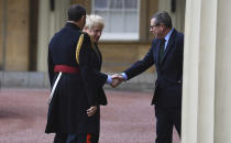 Britain's Prime Minister Boris Johnson is greeted by the Queen's Equerry-in-Waiting Lieutenant Colonel Charles Richards, left and her private secretary Edward Young, as he arrives at London's Buckingham Palace for an audience with Britain's Queen Elizabeth II after the Conservative Party returned to power in the General Election with an increased majority, in London, Friday, Dec. 13, 2019. Johnson’s Conservative Party has won a thumping majority of seats in Britain's Parliament — a decisive outcome to a Brexit-dominated election that should allow Johnson to fulfill his plan to take the U.K. out of the European Union next month. (Victoria Jones/Pool Photo via AP)