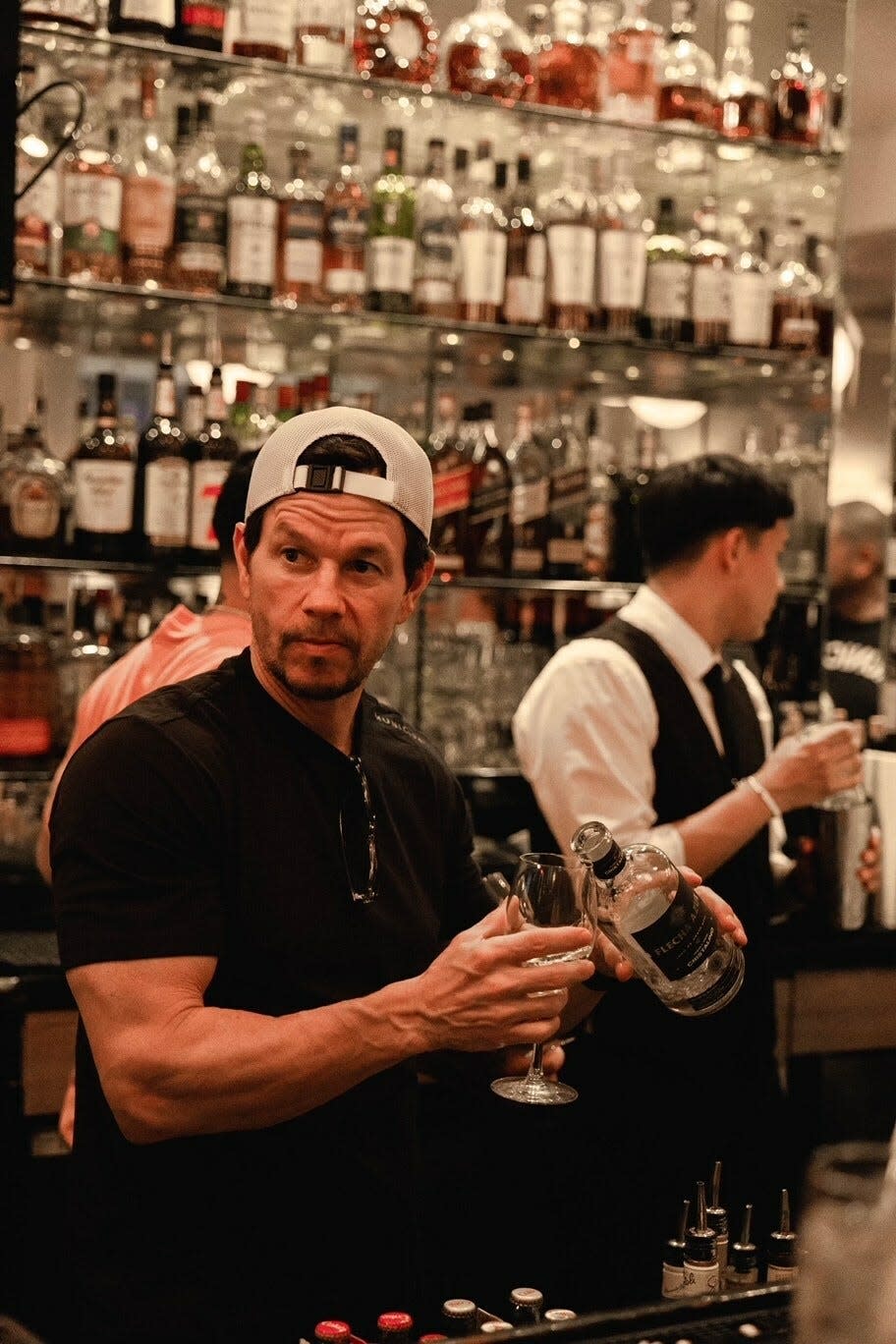 Mark Wahlberg pours Flecha Azul tequila at Bice Palm Beach on Saturday.