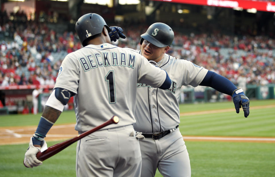 Seattle Mariners' Daniel Vogelbach, right, is congratulated by Tim Beckham after hitting a solo home run during the first inning of a baseball game against the Los Angeles Angels Saturday, April 20, 2019, in Anaheim, Calif. (AP Photo/Mark J. Terrill)