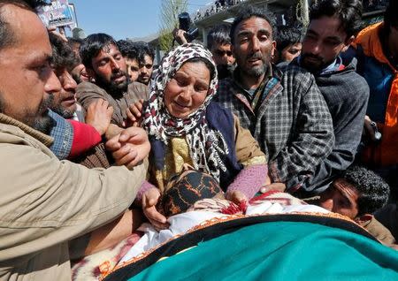 Relatives cry beside the body of Umar Farooq, a civilian who was killed on Sunday during a protest against by-polls, at his funeral in Barsoo village in Ganderbal district in Kashmir April 10, 2017. REUTERS/Danish Ismail