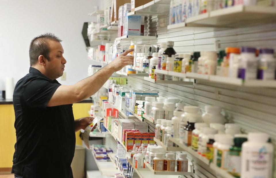 Pharmacy tech Deepan Kalikotay pulls medicine for a prescription at BestCare Pharmacy in Akron.