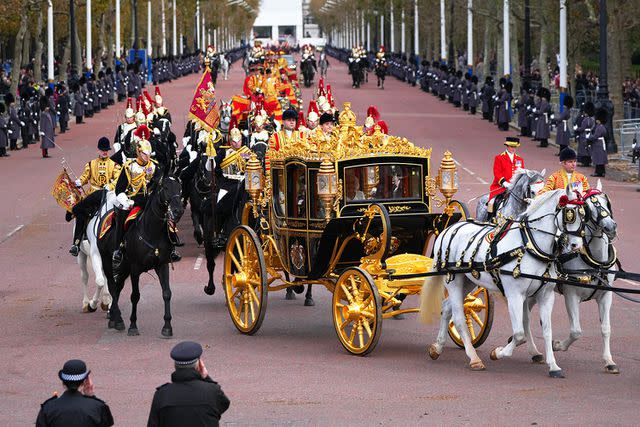 <p>Carl Court/Getty</p> King Charles and Queen Camilla travel towards Buckingham Palace in the Diamond Jubilee State Coach after attending the State Opening of Parliament on November 7, 2023.