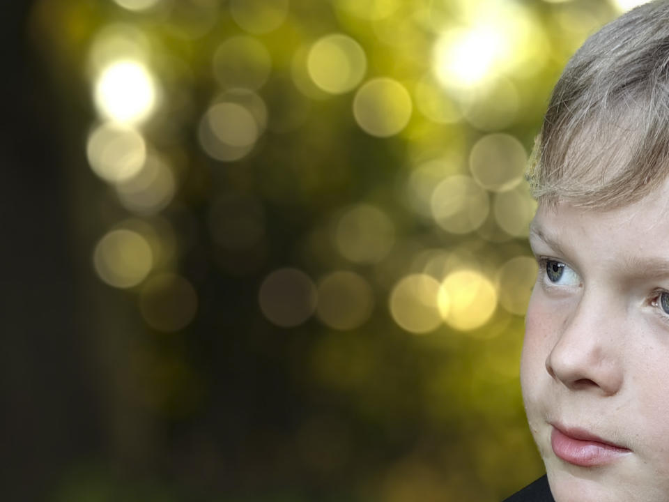 Close up of outdoors portrait taken with the Huawei P60 Pro showing tree-dappled sunset bokeh detail