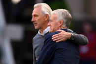 <p>The two coaches embrace at the conclusion of the Group C match </p>