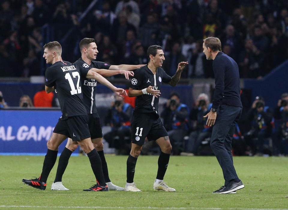 PSG forward Angel Di Maria, second right, celebrates with coach Thomas Tuchel, right, and teammates after scoring his side's second goal during a Group C Champions League soccer match between Paris Saint Germain and Napoli at the Parc des Princes stadium in Paris, Wednesday Oct. 24, 2018. (AP Photo/Thibault Camus)