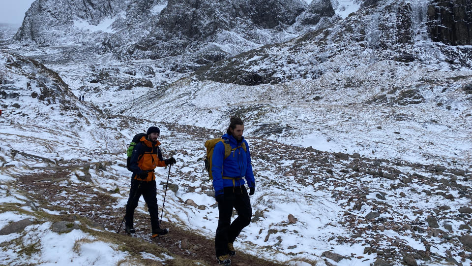 Two hikers walking through a snowy landscape