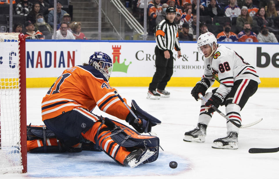 Chicago Blackhawks' Patrick Kane (88) is stopped by Edmonton Oilers goalie Mike Smith (41) during the third period of an NHL hockey game Wednesday, Feb. 9, 2022, in Edmonton, Alberta. (Jason Franson/The Canadian Press via AP)