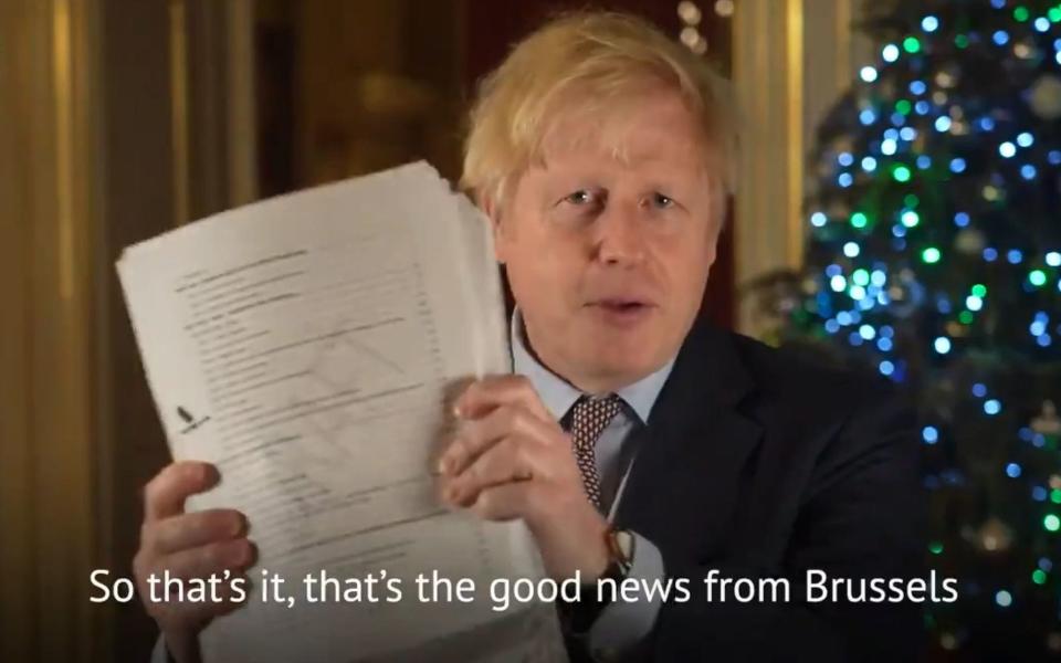 Boris Johnson with the deal document during a Christmas messaged posted on Twitter