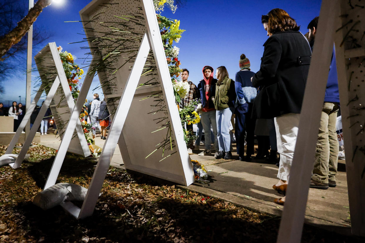 People attend a memorial service on Saturday, Nov. 19, 2022, at John Paul Jones Arena on the campus of the University of Virginia in Charlottesville, Va., for three slain University of Virginia football players, who were fatally shot as they returned from a field trip last weekend. (Shaban Athuman/Richmond Times-Dispatch via AP)