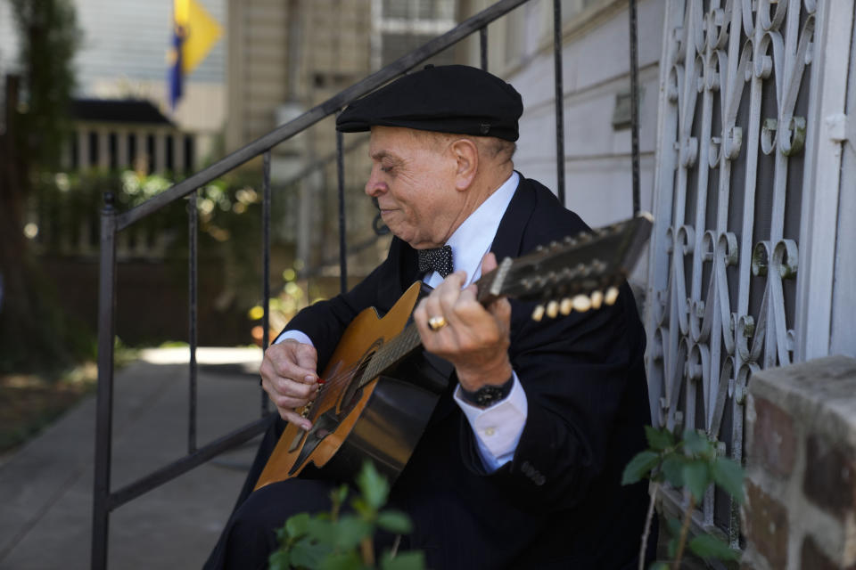 Guitarist and singer Deacon John Moore strums a guitar at his home in New Orleans, Wednesday, May 3, 2023. Moore has been a regular performer at the New Orleans Jazz & Heritage Festival since it began in 1970, and is playing the festival again this year. (AP Photo/Gerald Herbert)