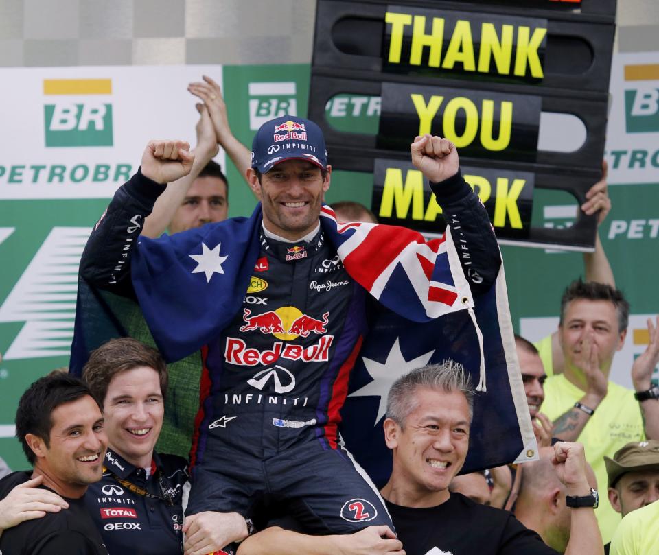 Mark Webber of Australia is carried as the Red Bull team celebrates their win in the F1 Grand Prix, after the Brazilian F1 Grand Prix at the Interlagos circuit in Sao Paulo