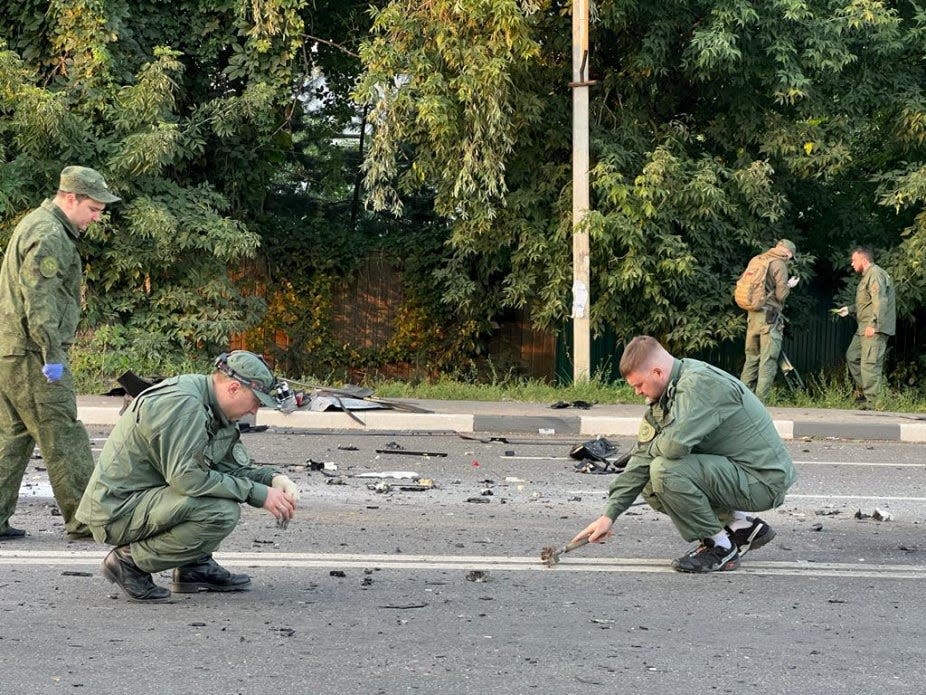 Investigators work at the site of a suspected car bomb attack that killed Darya Dugina, daughter of ultra-nationalist Russian ideologue Alexander Dugin, in the Moscow region, Russia August 21, 2022.