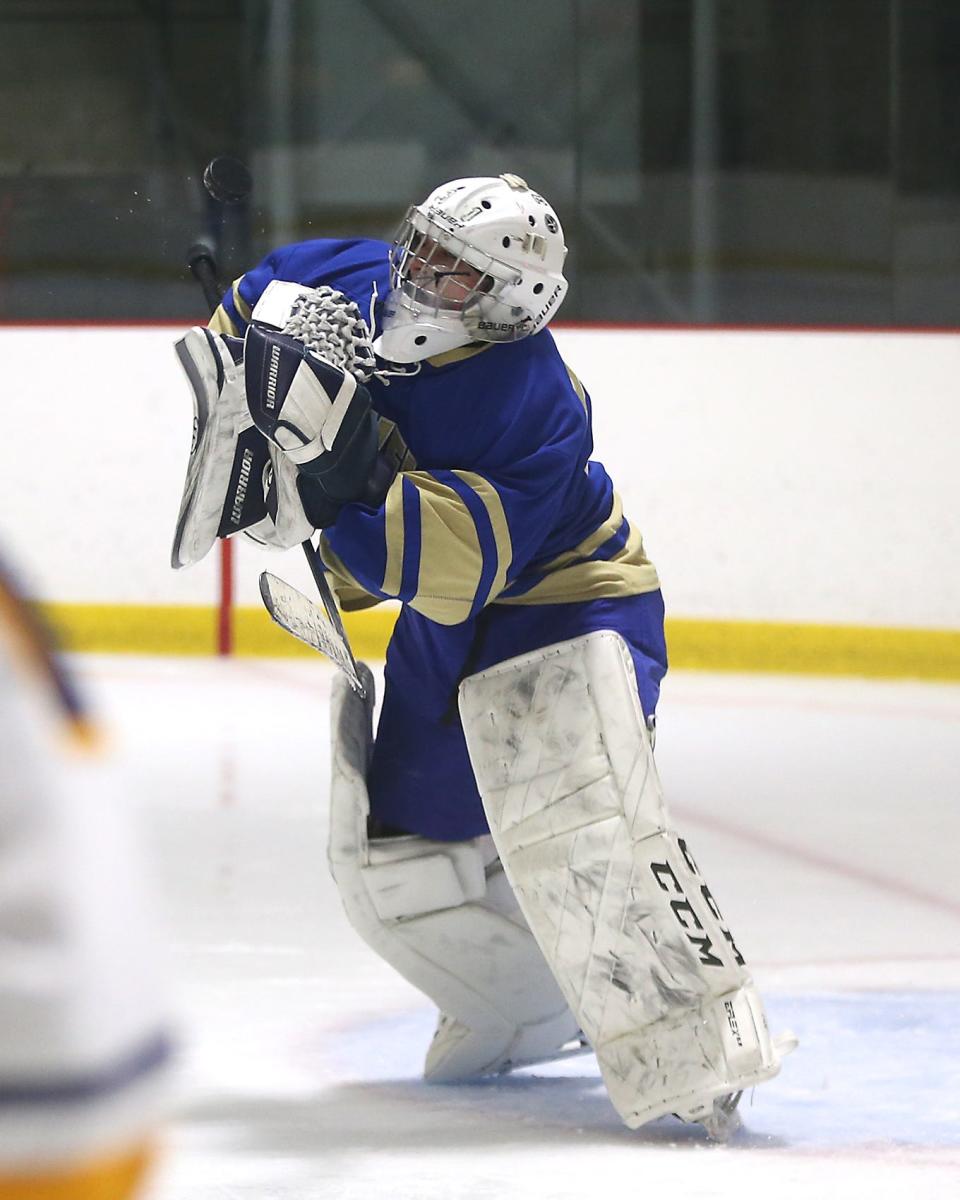 Norwell goalie Sean Donovan makes a save during third period action of their game against Cohasset/ Hull at Connell Rink and Pool in Weymouth on Saturday, Jan. 21, 2023. 
