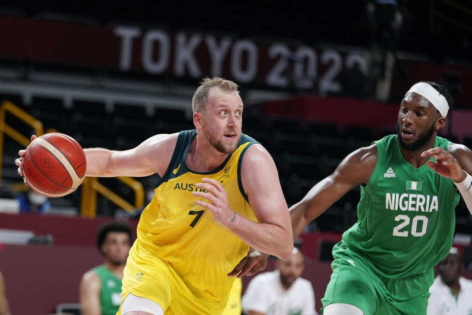 Australia's Joe Ingles drives to the basket past Nigeria's Josh Okogie (20) during a men's basketball preliminary round game at the 2020 Summer Olympics, Sunday, July 25, 2021, in Saitama, Japan. (AP Photo/Charlie Neibergall)