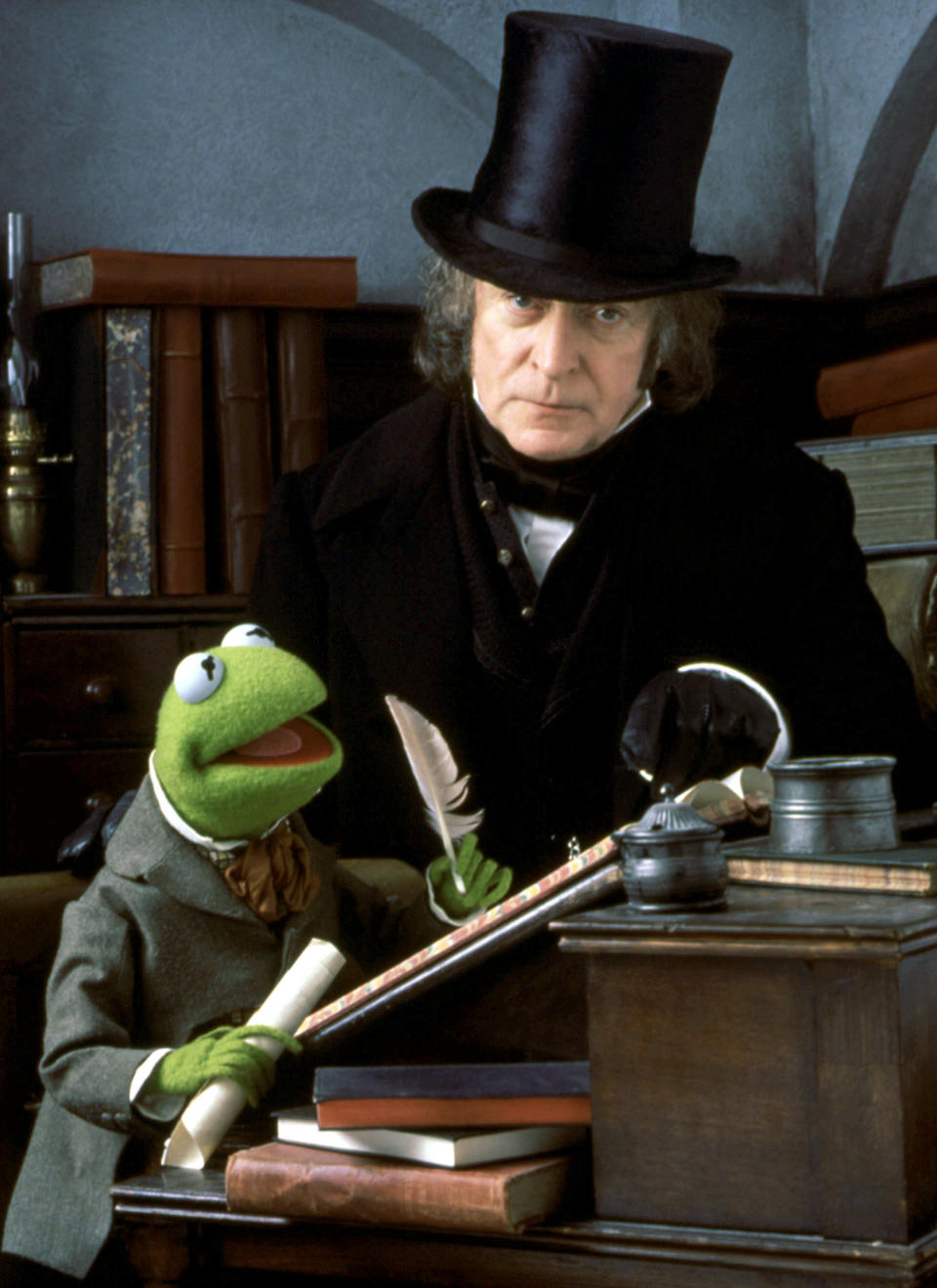 Scrooge and Kermit sitting at a desk