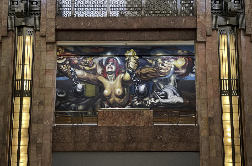 “The new democracy” mural by Mexican artist David Alfaro Siqueiros is displayed in the Palacio Bellas Artes, in Mexico City, Tuesday, Aug. 2, 2022. The 88-year-old palatial art nouveau performing arts center's interior walls are graced with famous murals by Siqueiros, Diego Rivera and Jose Clemente Orozco. (AP Photo/Fernando Llano)