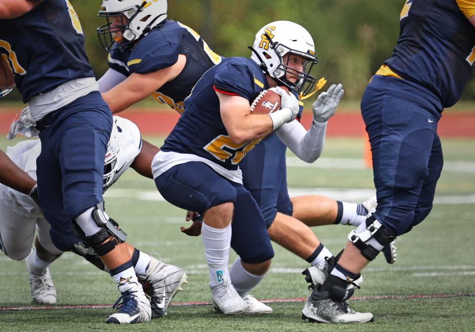 Siena Heights' Ethan LoPresto runs the ball during Saturday's game at St. Ambrose.