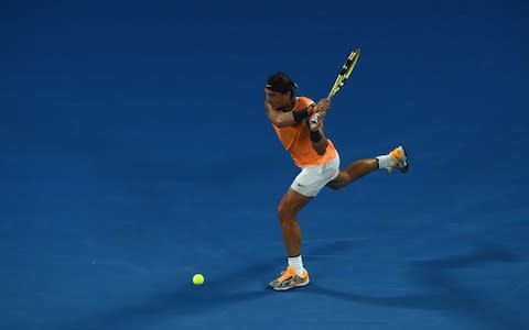 Spain's Rafael Nadal plays a backhand return Frances Tiafoe of the US during their men's singles quarter-final match on day nine of the Australian Open tennis tournament in Melbourne on January 22, 2019 - Credit: AFP