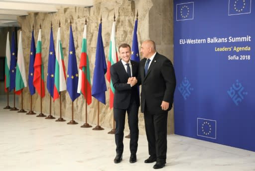 Bulgarian Prime Minister Boyko Borisov welcomes French President Emmanuel Macron on his arrival for an EU-Western Balkans summit in Sofia on May 17, 2018