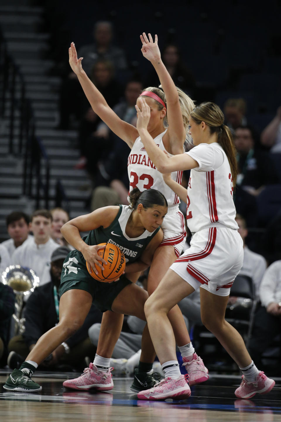 Michigan State guard Moira Joiner tries to find a way between Indiana guard Sydney Parrish (33) and forward Alyssa Geary, right, in the second half of an NCAA college basketball game at the Big Ten women's tournament Friday, March 3, 2023, in Minneapolis. Indiana won 94-85. (AP Photo/Bruce Kluckhohn)