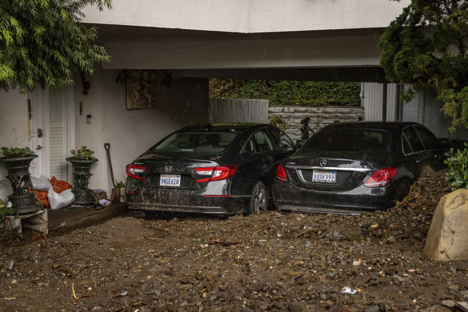 Cars sit submerged by a mudslide Tuesday, Feb. 6, 2024, in the Beverly Crest area of Los Angeles. (AP Photo/Ethan Swope)