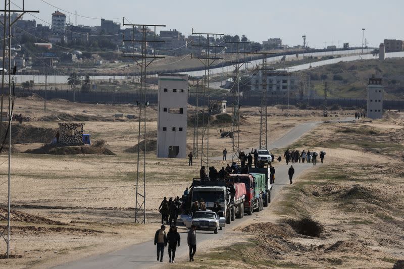 Trucks with aid move along the border with Egypt, in Rafah