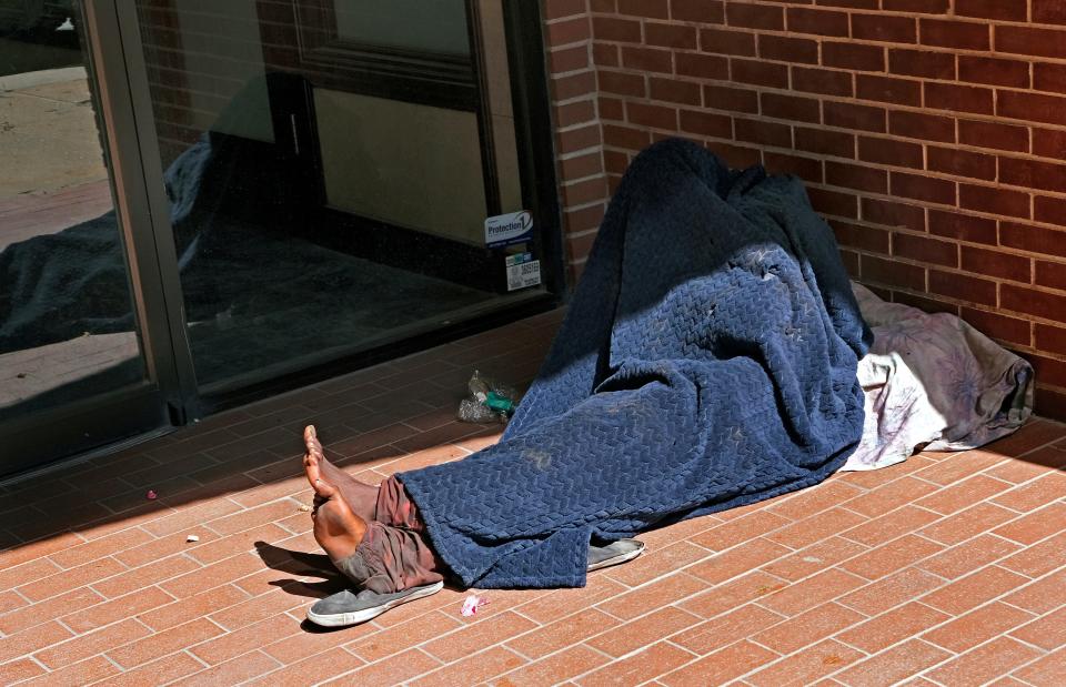 A person sleeps in a doorway along Robinson Ave. in downtown Oklahoma City, Tuesday, June 28, 2022.