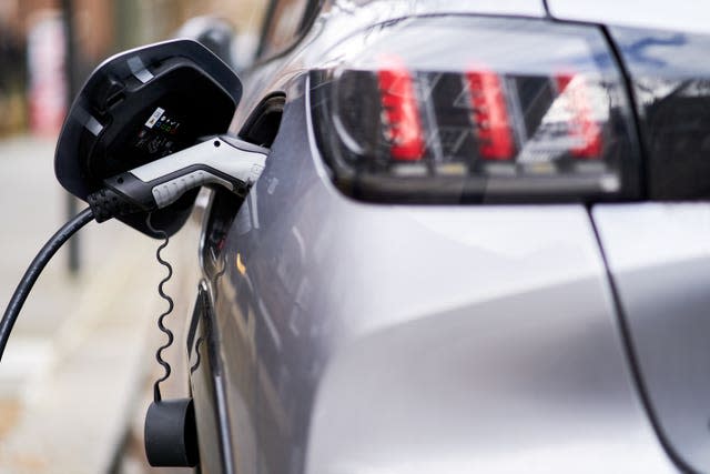 An electric vehicle at a charging station (John Walton/PA)