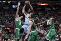 Miami Heat forward Jimmy Butler shoots as Boston Celtics center Daniel Theis (27), forward Gordon Hayward, center, and guard Jaylen Brown, right, defend during the first half of an NBA basketball game, Tuesday, Jan. 28, 2020, in Miami. (AP Photo/Lynne Sladky)