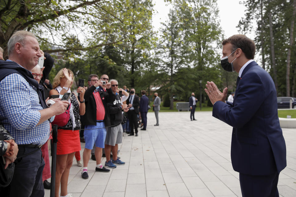French President Emmanuel Macron greets voters during the first round of French regional and departmental elections, in Le Touquet-Paris-Plage, northern France, Sunday, June 20, 2021. The elections for leadership councils of France's 13 regions, from Brittany to Burgundy to the French Riviera, are primarily about local issues like transportation, schools and infrastructure. But leading politicians are using them as a platform to test ideas and win followers ahead of the April presidential election. (Christian Hartmann/Pool via AP)