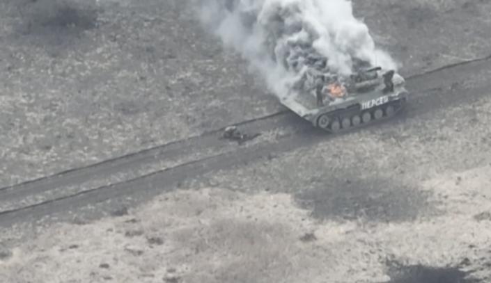 A Russian vehicle on fire after being struck by a Javelin missile.