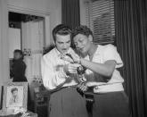 <p>Louie Bellson gives his fiancée, jazz musician Pearl Bailey, a diamond tennis bracelet before their wedding. The couple got married later that year and remained together until her death in 1990. </p>