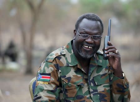 FILE PHOTO: Riek Machar, South Sudan's then rebel leader, talks on the phone in his field office in a rebel-controlled territory in Jonglei State, South Sudan, February 1, 2014. REUTERS/Goran Tomasevic/Files Photo