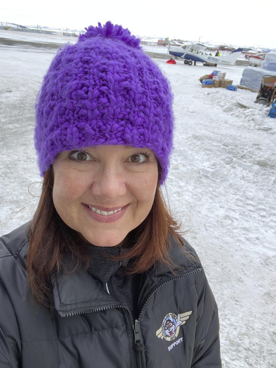 This March 13, 2020, photo, provided by Dr. Jodie Guest, an infectious disease epidemiologist at Emory University in Atlanta, shows Guest as an Iditarod Trail Sled Dog Race volunteer at a checkpoint in Unalakleet, Alaska. Guest will help advise the Iditarod as it plans to run the 2021 race amid the coronavirus pandemic. (Courtesy of Dr. Jodie Guest via AP)