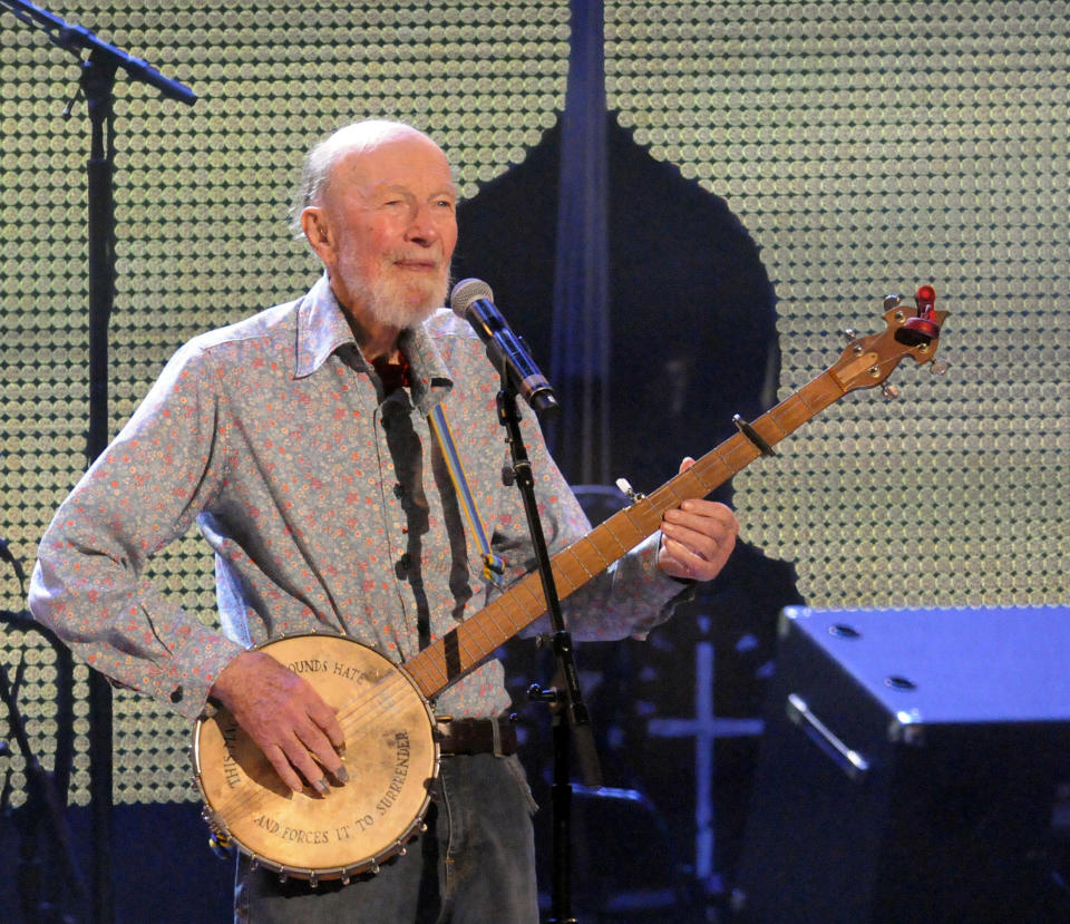 FILE- In this Sept. 21, 2013 file photo, Pete Seeger performs on stage during the Farm Aid 2013 concert at Saratoga Performing Arts Center in Saratoga Springs, N.Y. Seeger, who died on Jan 27, 2014 at age 94, will be honored with a few early event on Saturday, May 3, 2014, what would have been his 95th birthday. Suggestions for memorializing the singer/activist ranger from renaming a park in his home town to naming the new bridge that will replace the Tappan Zee bridge across the Hudson River in New York after him. (AP Photo/Hans Pennink, File)