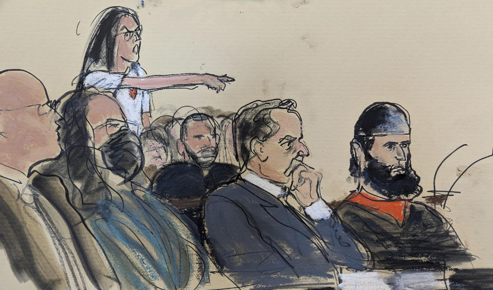 In this courtroom sketch, in federal court in New York, Wednesday, May 17, 2023, one of the victims of the bike path attack of Sayfullo Saipov, shouts from the audience after Saipov, seated right, finished his statement, during the sentencing phase of his trial. Saipov was given 10 life sentences and another 260 years in prison on Wednesday for killing eight people with a truck on a bike path in Manhattan and severely injuring 18 others. (AP Photo/Elizabeth Williams)