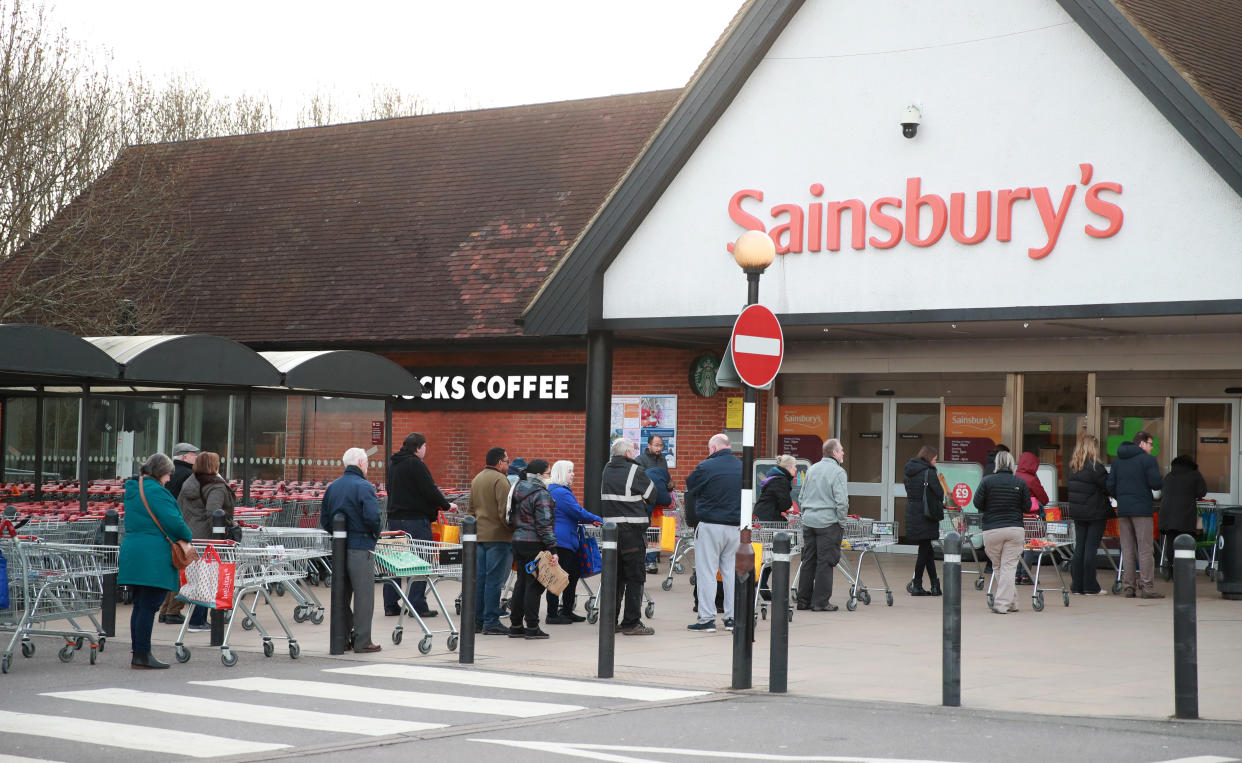 People queuing up outside Sainsburys in Guildford a day after the Chancellor unveiled an emergency package aimed at protecting workers' jobs and wages as they face hardship in the fight against the coronavirus pandemic.