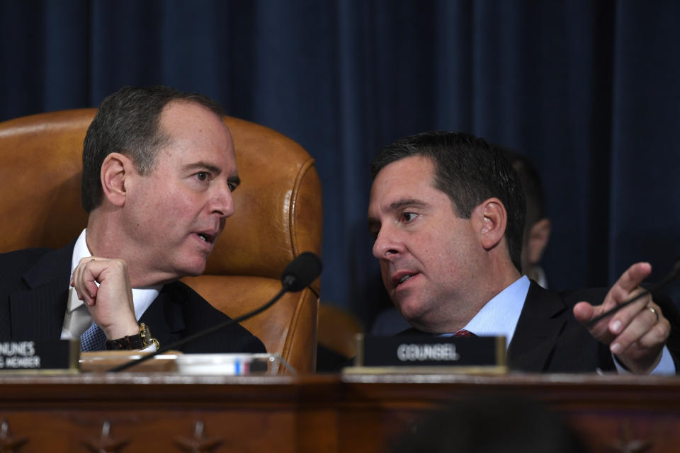 House Intelligence Committee Chairman Adam Schiff, D-Calif., left, talks with ranking member Devin Nunes, R-Calif., right, talk as top U.S. diplomat in Ukraine William Taylor and career Foreign Service officer George Kent testify before the House Intelligence Committee on Capitol Hill in Washington, Wednesday, Nov. 13, 2019, during the first public impeachment hearing of President Donald Trump's efforts to tie U.S. aid for Ukraine to investigations of his political opponents. (AP Photo/Susan Walsh)