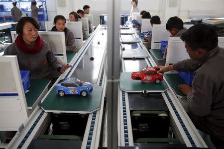 Students work on an improvised car assembly line as a group of foreign reporters visits a vocational school on a government organised tour in Lhasa, Tibet Autonomous Region, China in this November 19, 2015 file photo. REUTERS/Damir Sagolj/Files